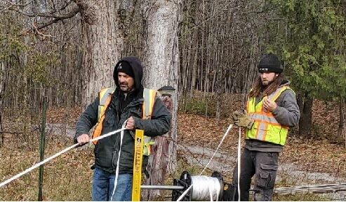 Our construction and operations Vice Preseident and a field technician pulling fibre in Clayton, Ontario.